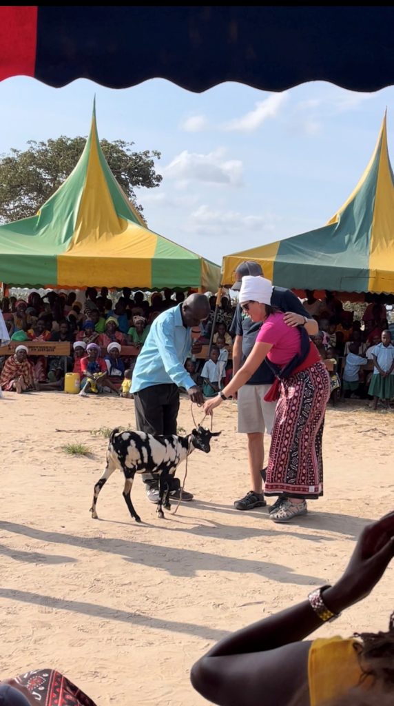 People of Nguluweni giving associate a goat as gift