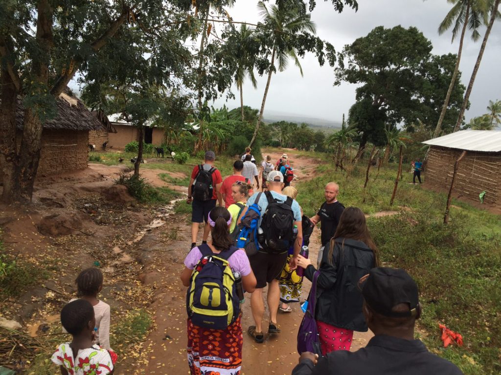 Volunteers walking through Boheka, Kenya with locals