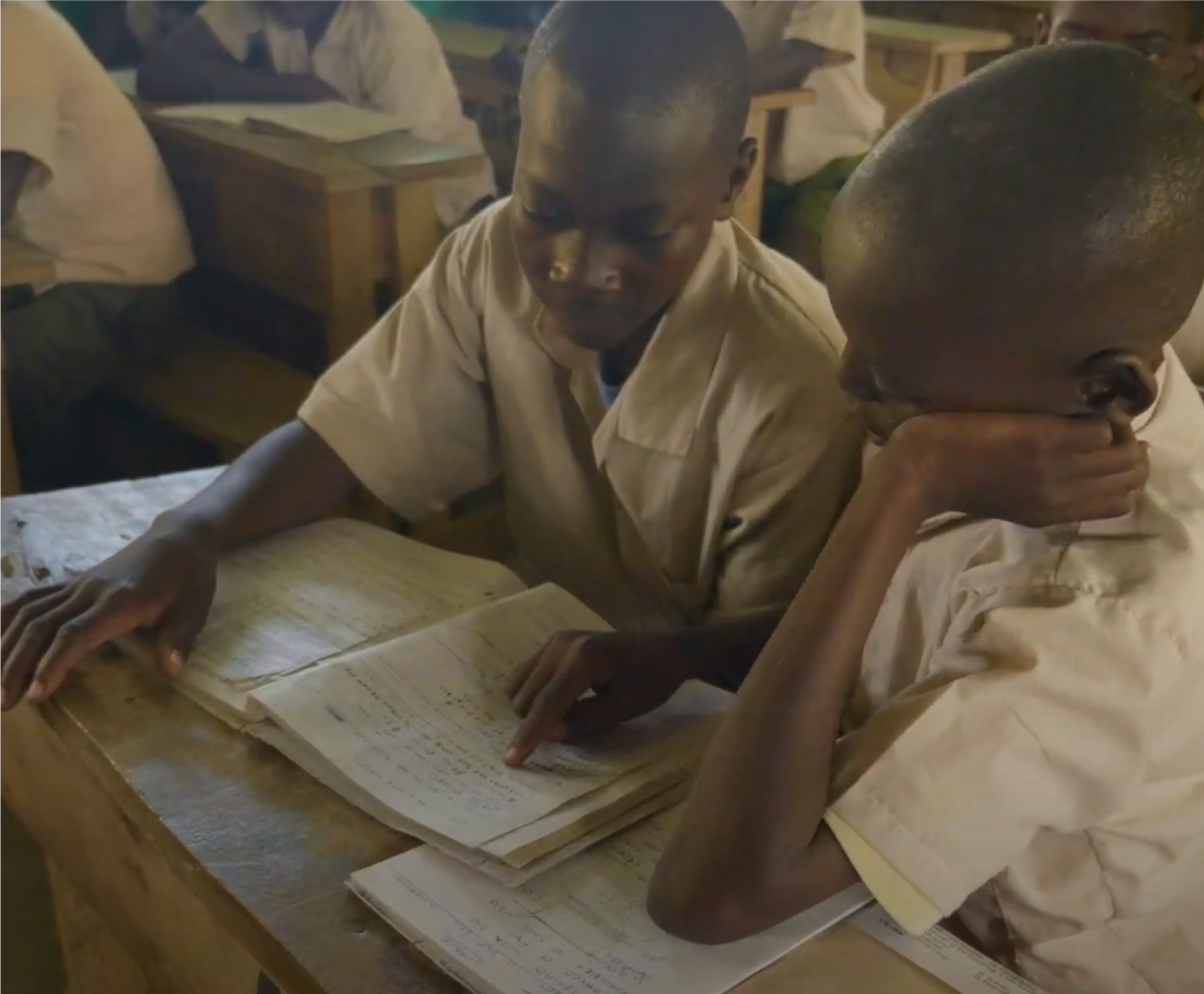 Two boys reading in newly constructed class building